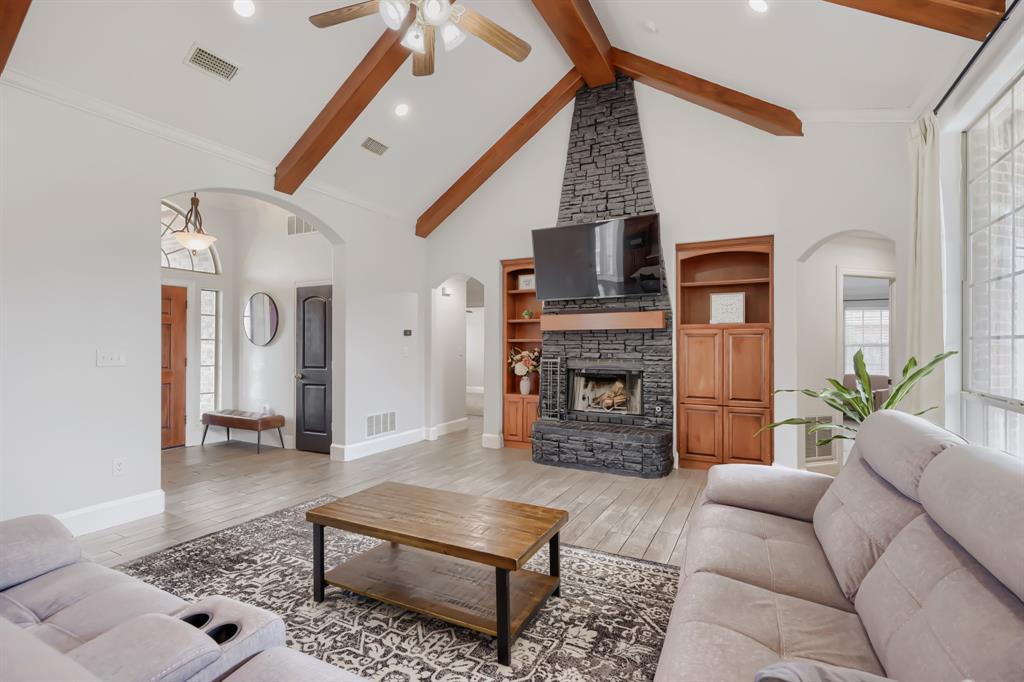 603 Ash Street Pilot Point, TX 76258 - Photo 8 of 28 Vaulted living space featuring exposed wood beams and a ceiling fan