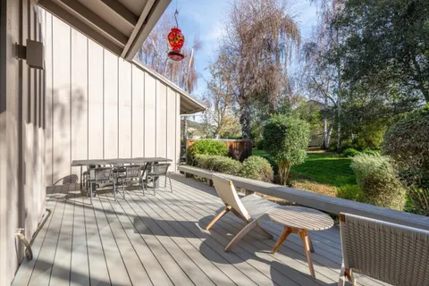 a view of balcony with chairs and wooden fence
