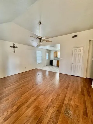 wooden floor in an empty room with a window