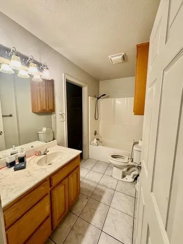a bathroom with a sink mirror and a shower