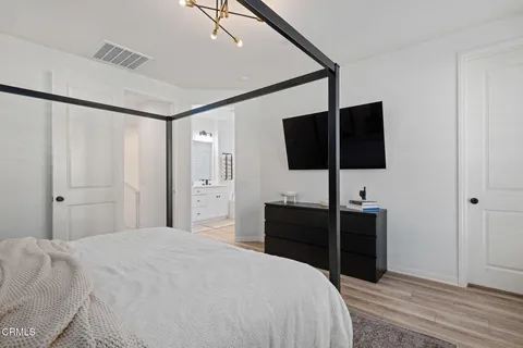 a bedroom with a bed and a flat screen tv