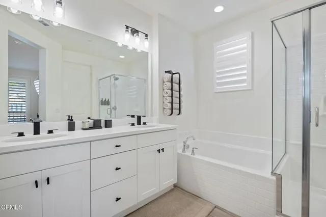 a bathroom with 2 sink tub and a mirror