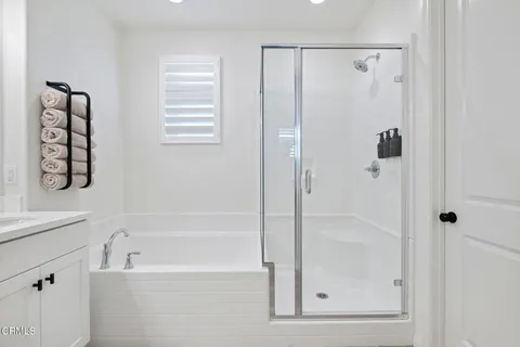 a bathroom with a bathtub and a shower