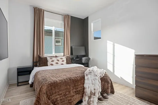 a bedroom with a bed and a window