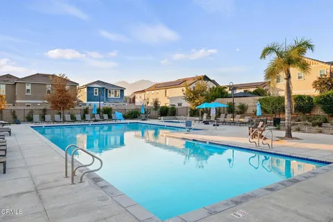 a view of a swimming pool and lounge chairs