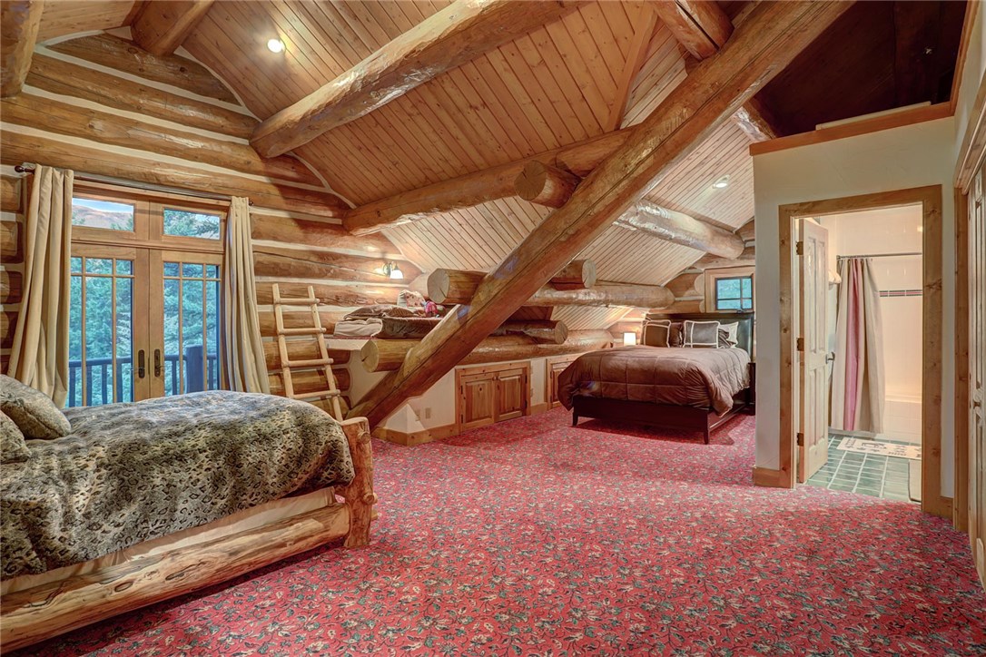 1381 Johnson Road Silverthorne, CO 80498 - Photo 25 of 35 Second upper level bedroom to the left of the stairs. This room has two queen beds, a lofted twin bed, and a full ensuite bathroom.