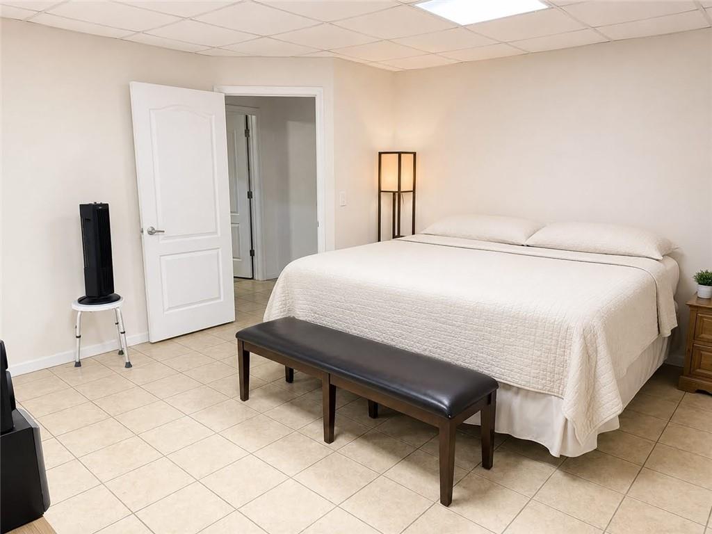 3776 Mason Ridge Drive Winston, GA 30187 - Photo 36 of 48 a bedroom with a bed and a flat tv screen on wall