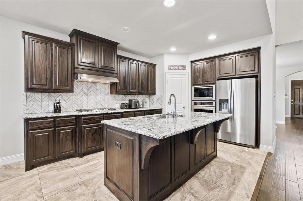 3500 Jersey Road Melissa, TX 75454 - Photo 9 of 40 a kitchen with stainless steel appliances granite countertop a stove a sink dishwasher a refrigerator and a oven with wooden floor