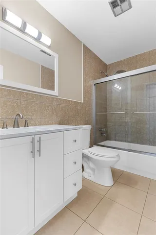 a bathroom with a toilet sink and shower