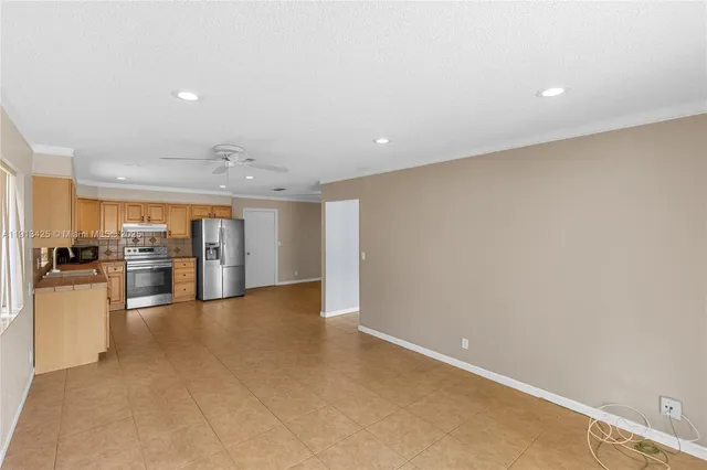 a view of a kitchen with a sink and a refrigerator
