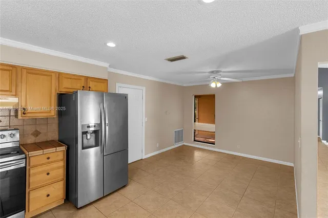 a kitchen with cabinets and stainless steel appliances