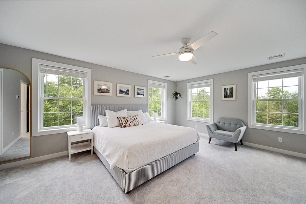 7 Kennard Road Epping, NH 03042 - Photo 13 of 42 a bedroom with a bed and large windows