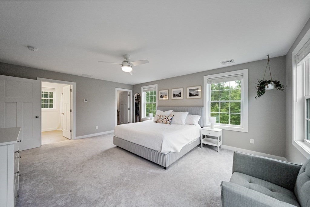 7 Kennard Road Epping, NH 03042 - Photo 14 of 42 a spacious bedroom with a bed and a window