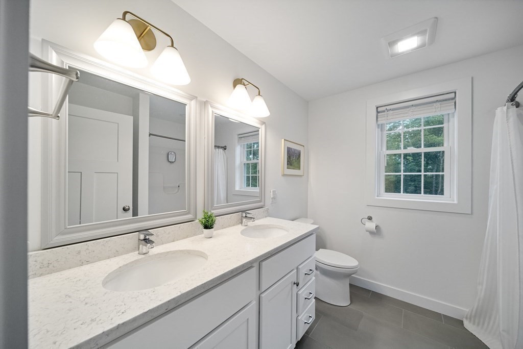 7 Kennard Road Epping, NH 03042 - Photo 15 of 42 a bathroom with a double vanity sink toilet and a mirror