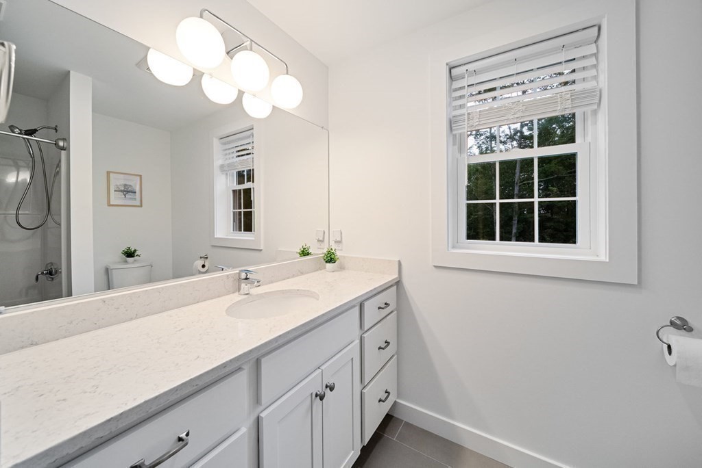 7 Kennard Road Epping, NH 03042 - Photo 22 of 42 a bathroom with a sink and a mirror