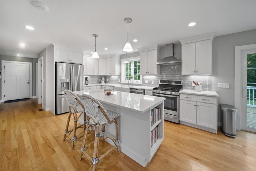 7 Kennard Road Epping, NH 03042 - Photo 3 of 42 a kitchen with a sink a center island stainless steel appliances and cabinets