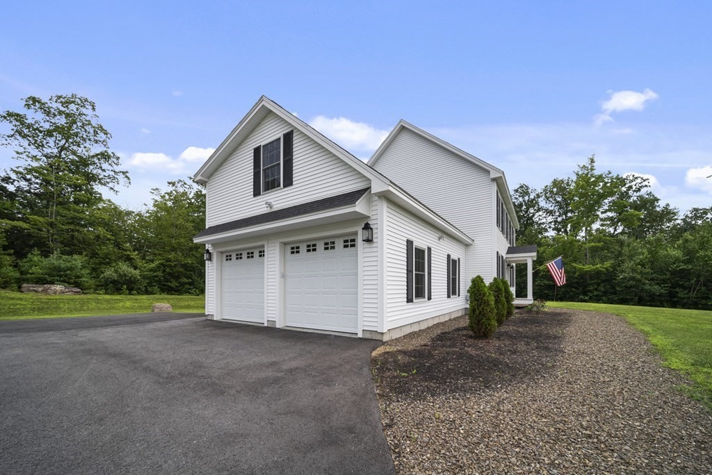 7 Kennard Road Epping, NH 03042 - Photo 36 of 42 a view of a house with a yard and garage