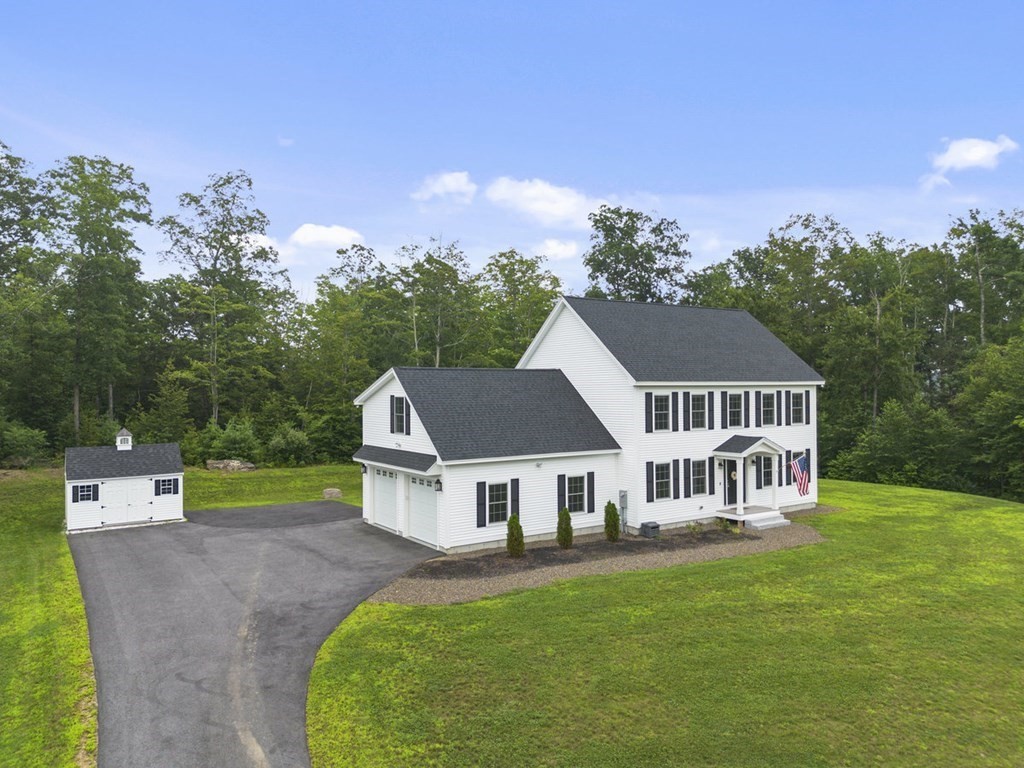 7 Kennard Road Epping, NH 03042 - Photo 38 of 42 a aerial view of a house with a yard table and chairs
