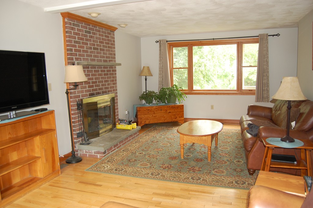 81 Old Ferry Road Haverhill, MA 01830 - Photo 12 of 17 a living room with furniture a flat screen tv and a fireplace