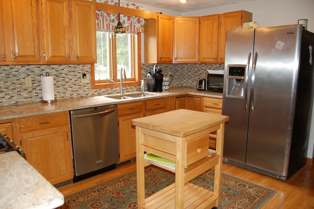 81 Old Ferry Road Haverhill, MA 01830 - Photo 7 of 17 a kitchen with a refrigerator a sink a stove and cabinets