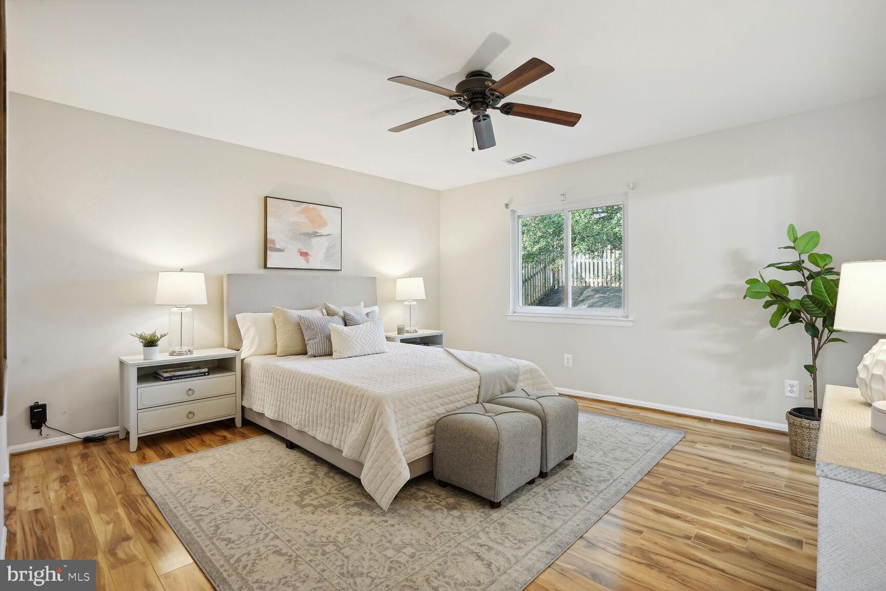 11408 Turnmill Lane Reston, VA 20191 - Photo 11 of 17 a bedroom with a bed and a potted plant