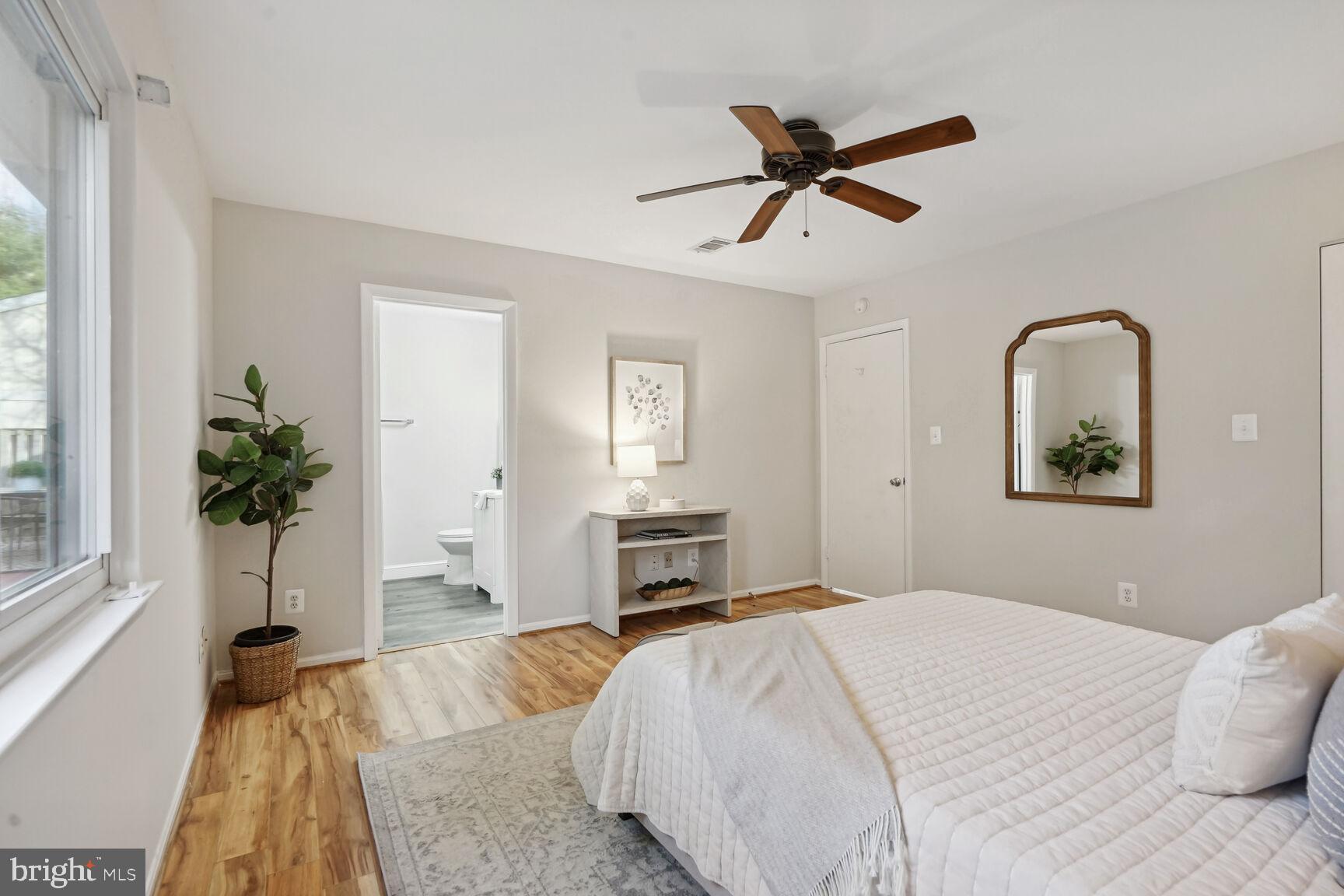 11408 Turnmill Lane Reston, VA 20191 - Photo 12 of 17 a bedroom with a bed and a potted plant