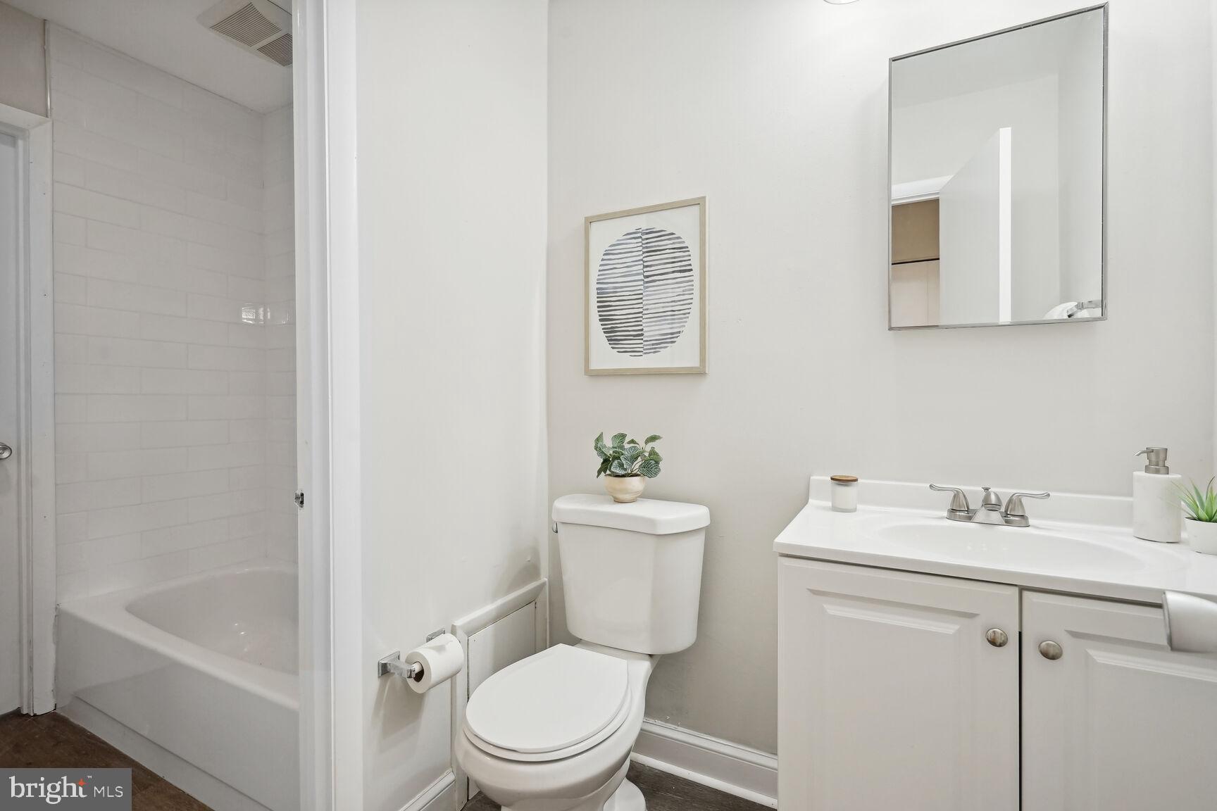 11408 Turnmill Lane Reston, VA 20191 - Photo 14 of 17 a white toilet sitting next to a bathroom sink
