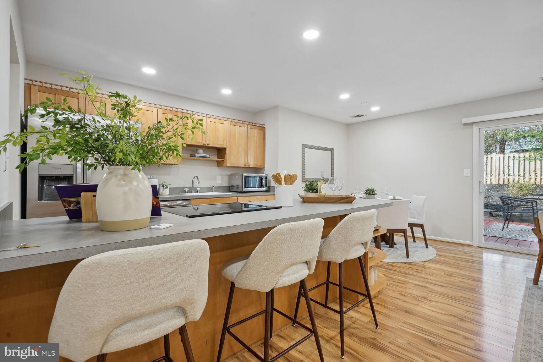 11408 Turnmill Lane Reston, VA 20191 - Photo 5 of 17 a kitchen with a table chairs refrigerator and cabinets