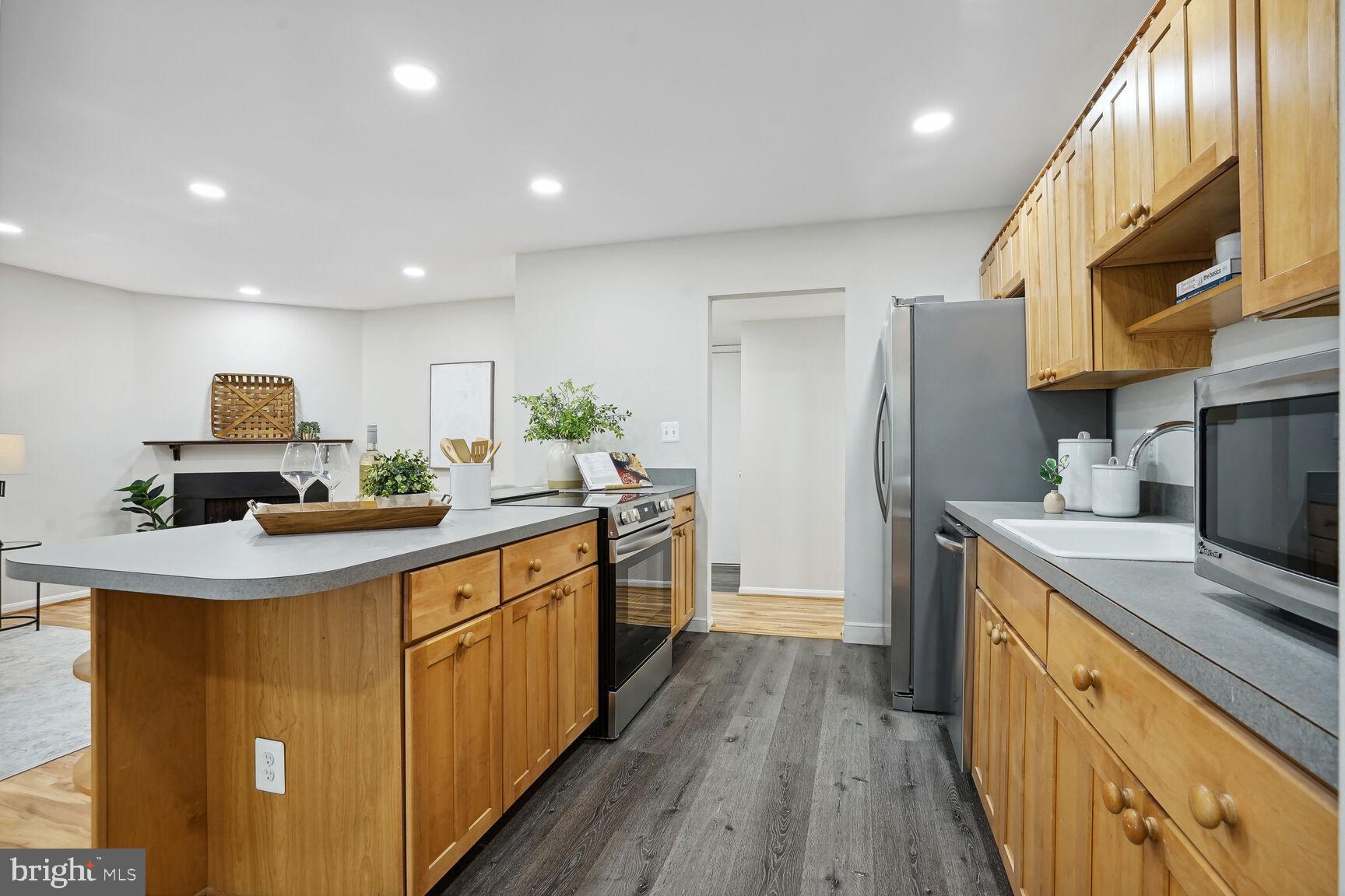 11408 Turnmill Lane Reston, VA 20191 - Photo 7 of 17 a kitchen with stainless steel appliances a sink stove and refrigerator
