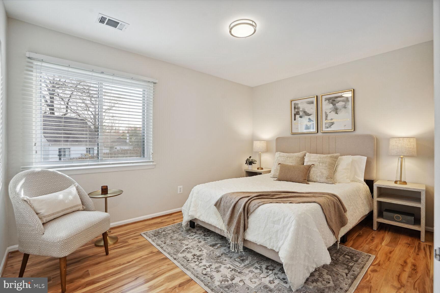 11408 Turnmill Lane Reston, VA 20191 - Photo 10 of 17 a bedroom with a bed and a chair