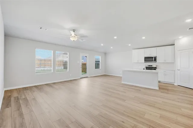 a view of kitchen with cabinets and wooden floor