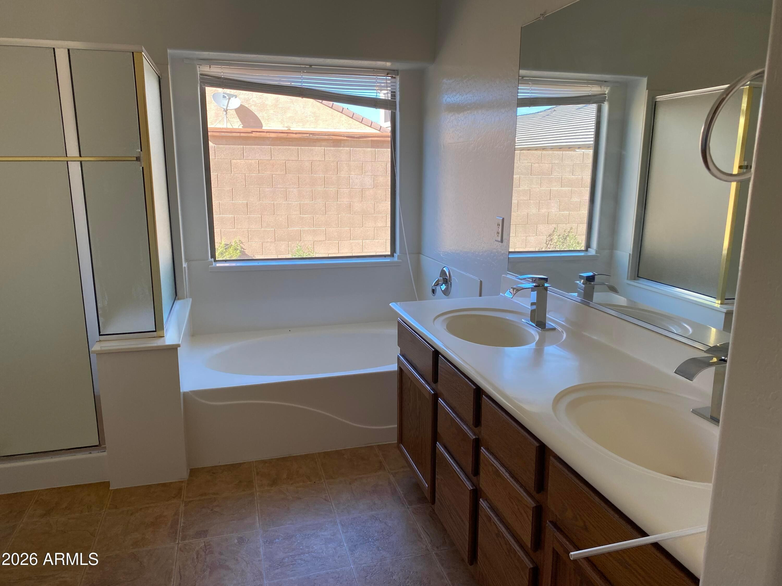 9124 West Heber Road Tolleson, AZ 85353 - Photo 16 of 26 a bathroom with a tub sink and mirror