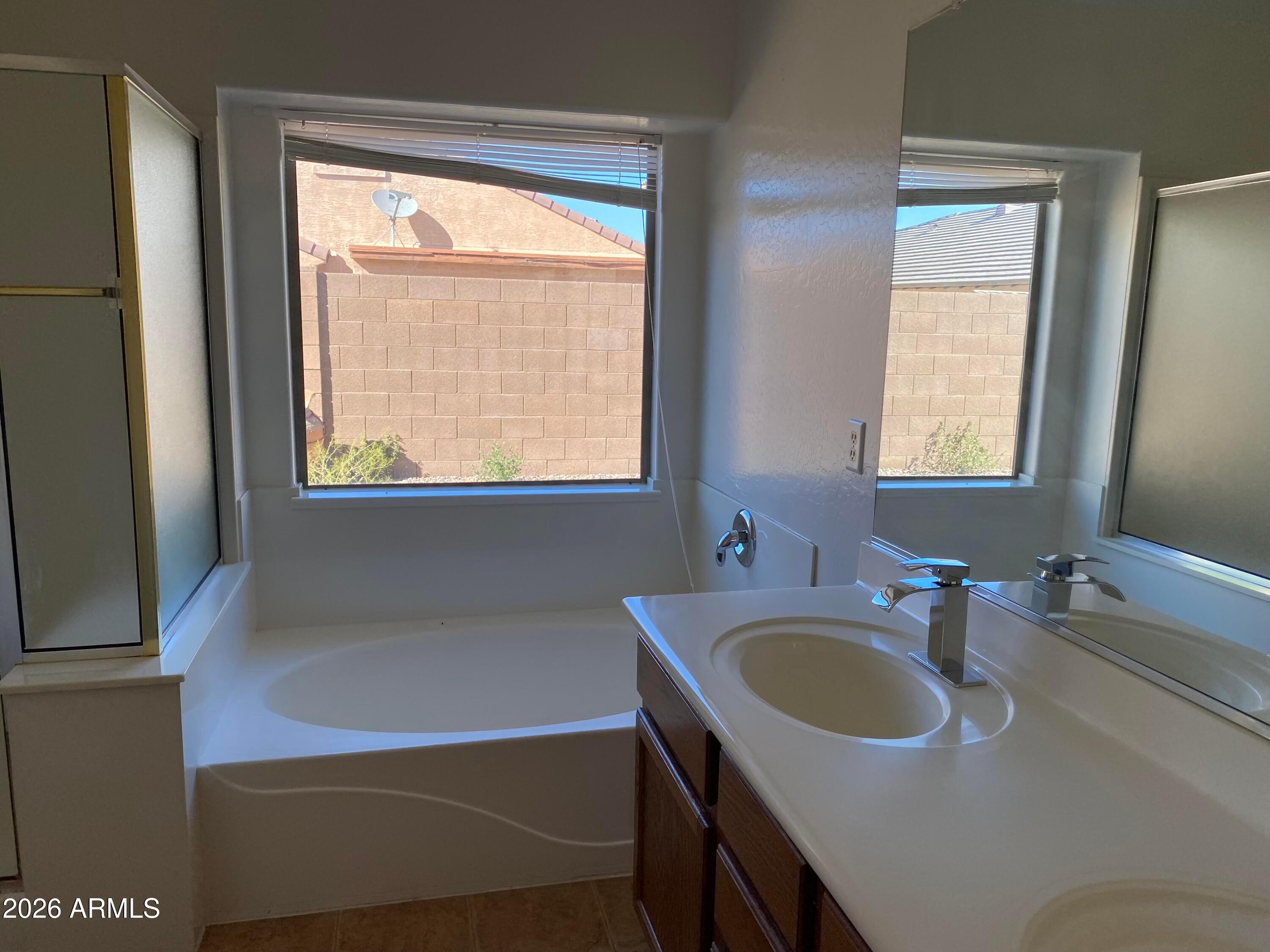 9124 West Heber Road Tolleson, AZ 85353 - Photo 17 of 26 a bathroom with a sink and a bathtub