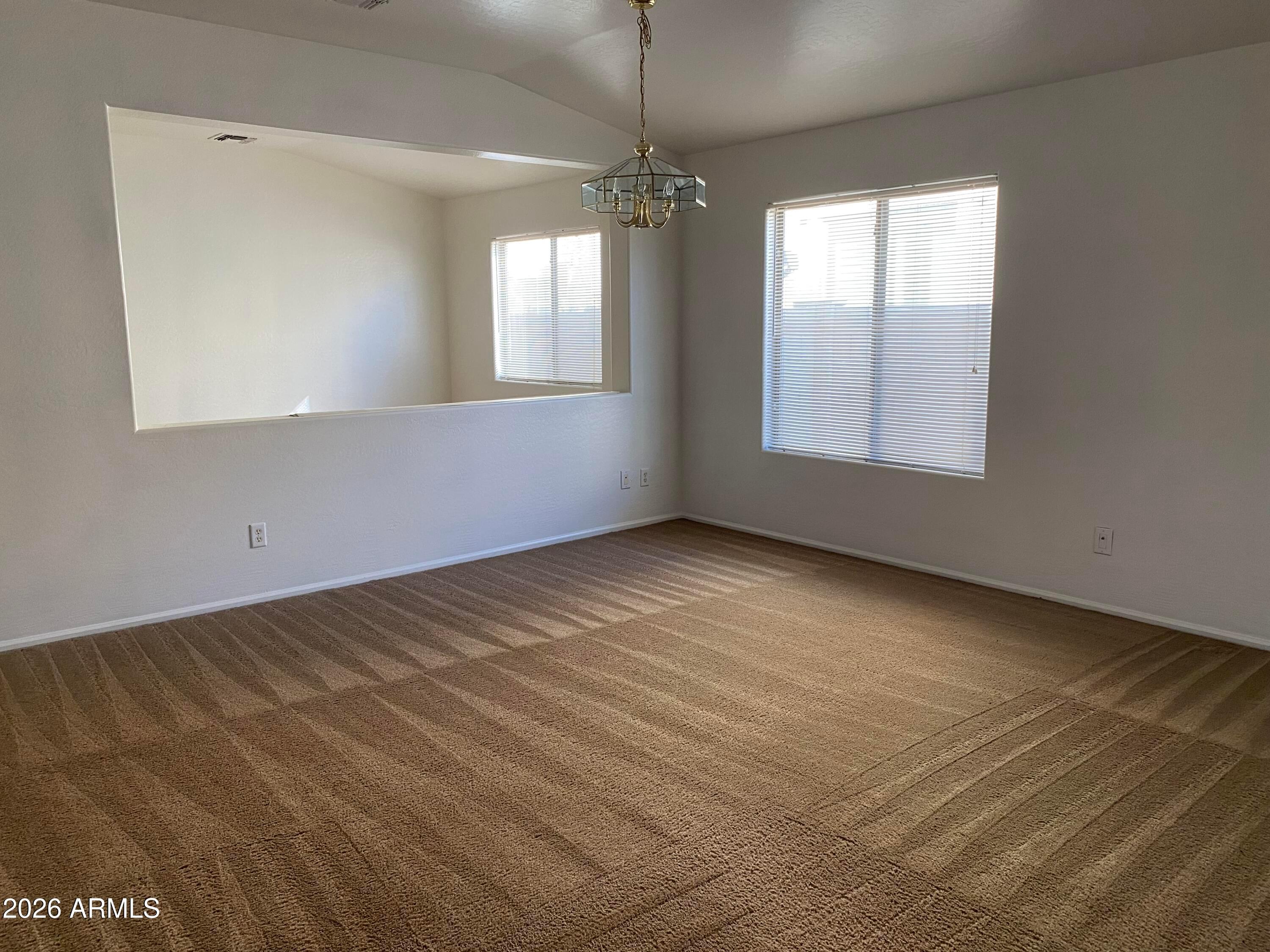 9124 West Heber Road Tolleson, AZ 85353 - Photo 2 of 26 a view of an empty room with a window
