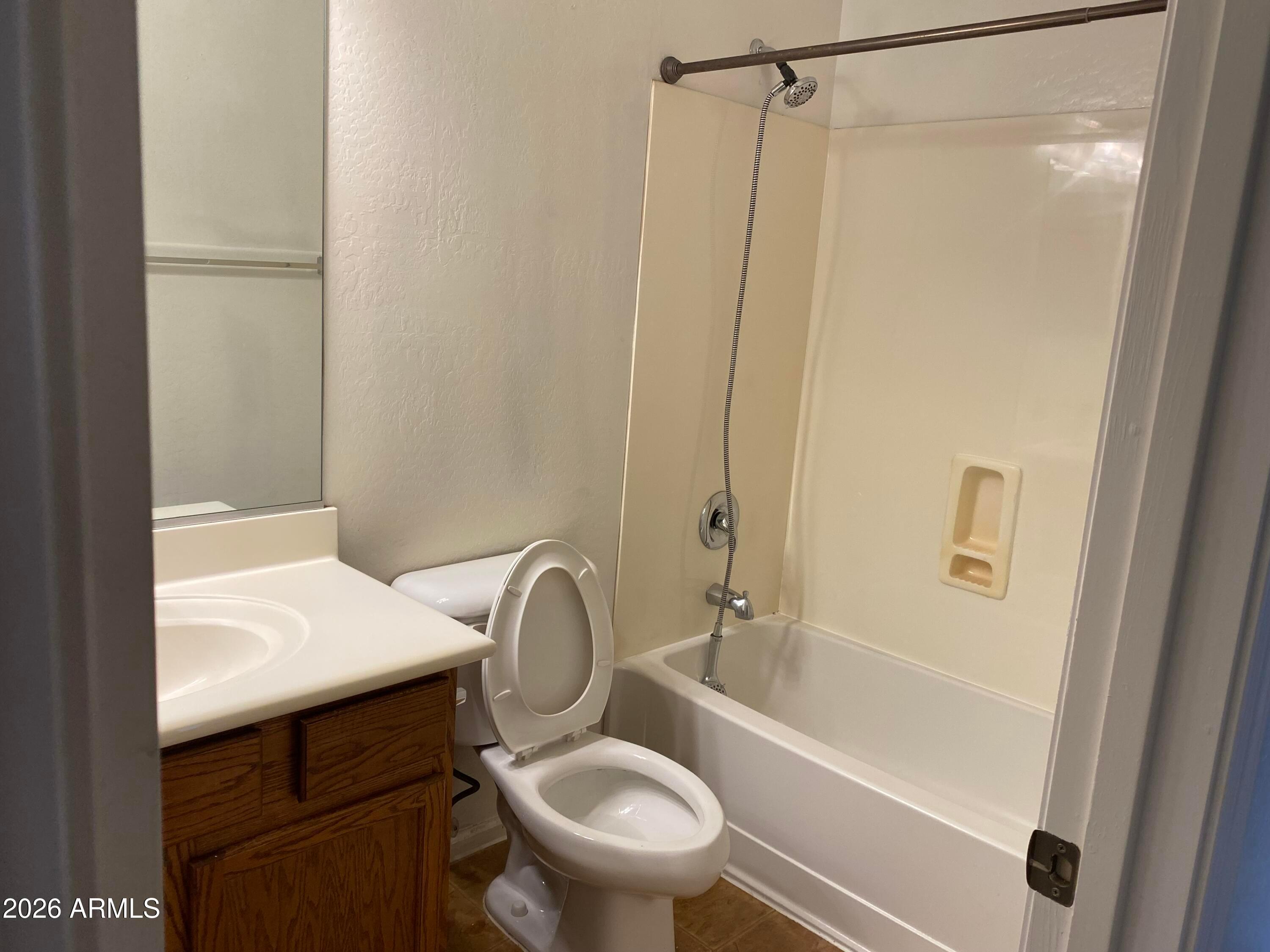 9124 West Heber Road Tolleson, AZ 85353 - Photo 23 of 26 a bathroom with a sink a toilet and shower