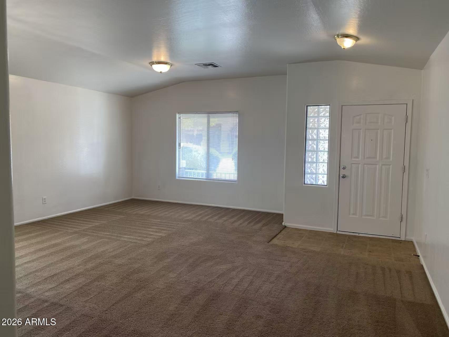 9124 West Heber Road Tolleson, AZ 85353 - Photo 4 of 26 an empty room with windows
