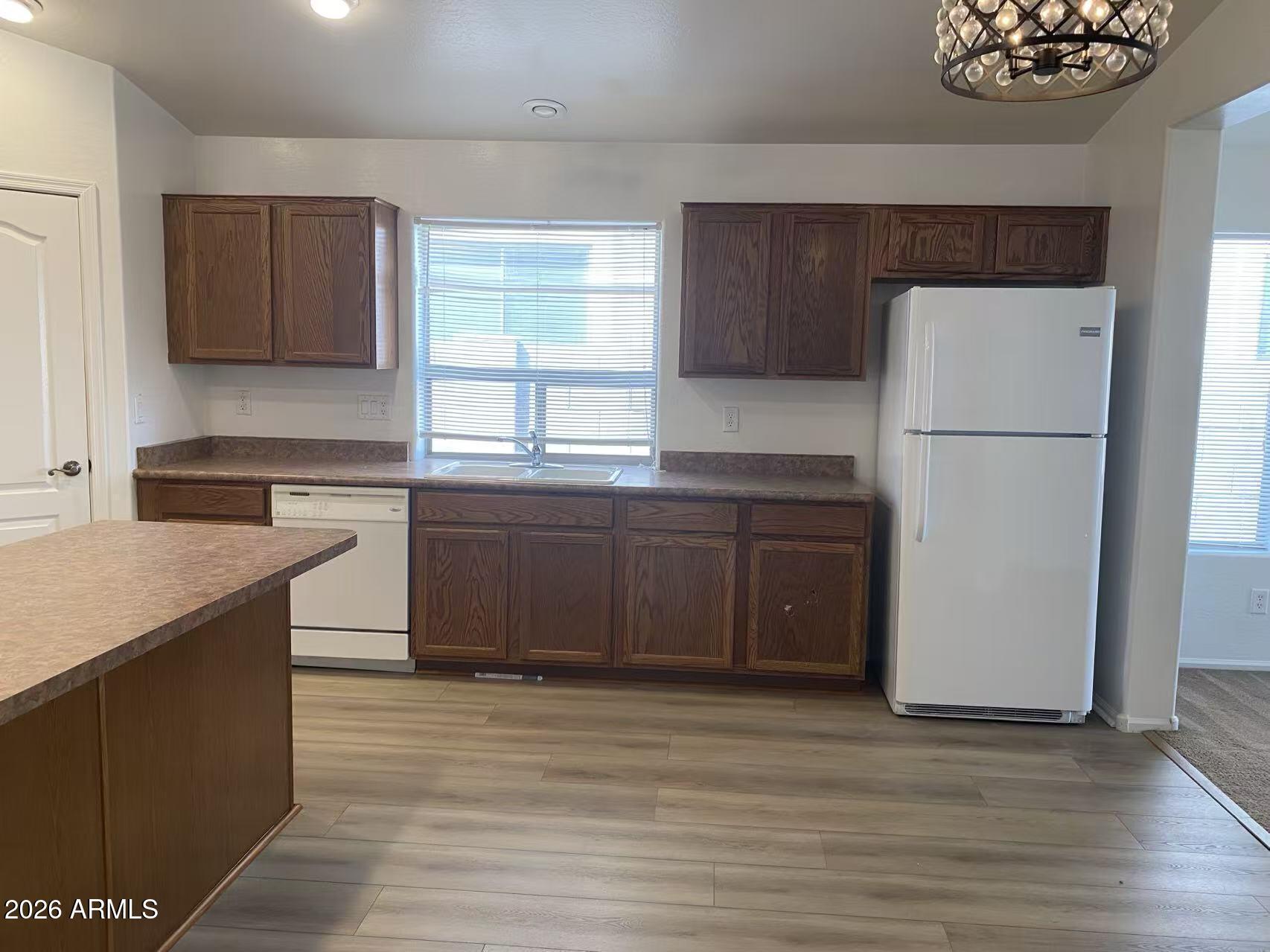 9124 West Heber Road Tolleson, AZ 85353 - Photo 8 of 26 a kitchen with a sink a stove a refrigerator and a window