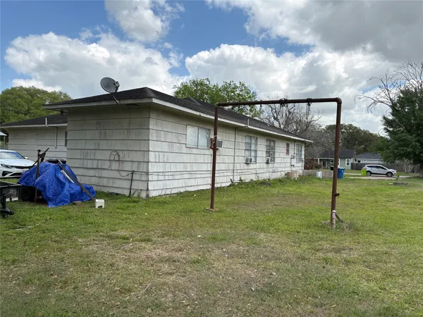 a view of backyard with wooden fence