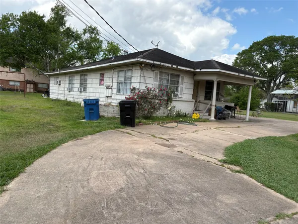 a view of a house with a yard and sitting area