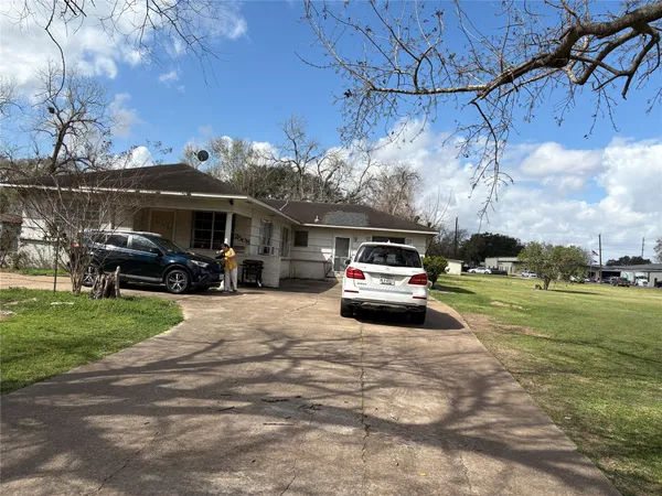a car parked in the yard of a house