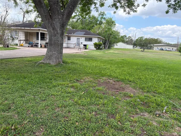 a front view of house with yard and trees