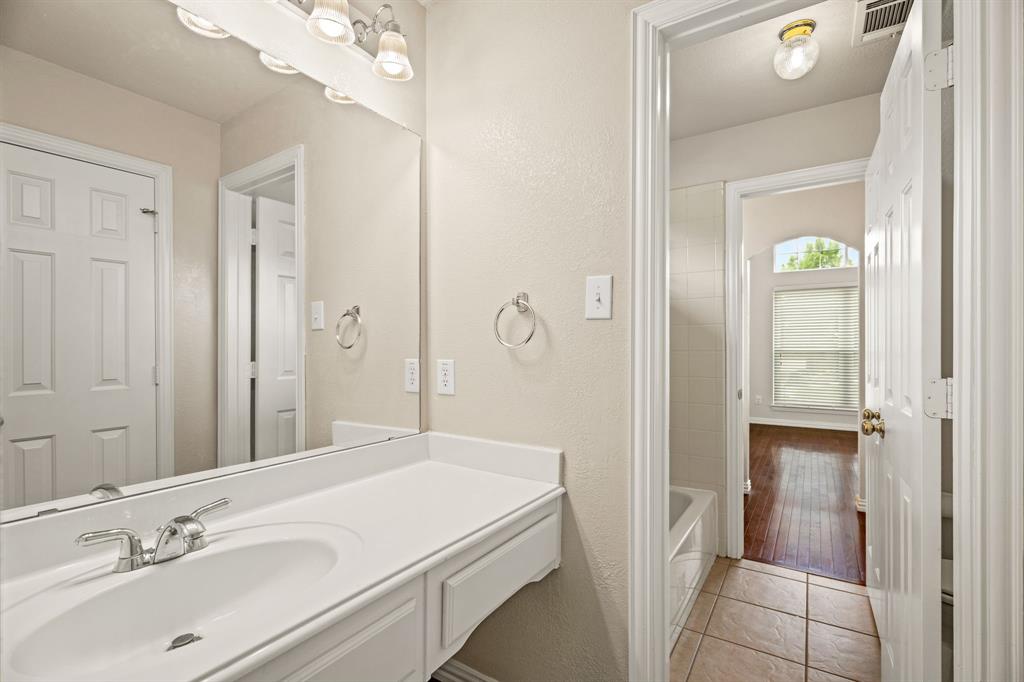 2012 Burnside Drive Allen, TX 75013 - Photo 33 of 40 a en suite bathroom with a granite countertop sink mirror and shower