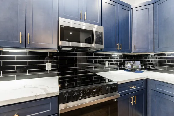 a kitchen with a stove and a microwave