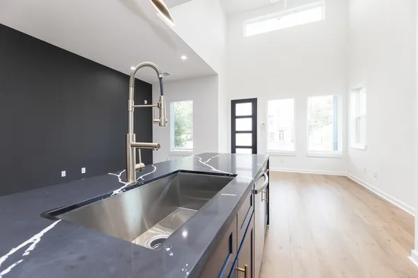 a kitchen with a sink and large window