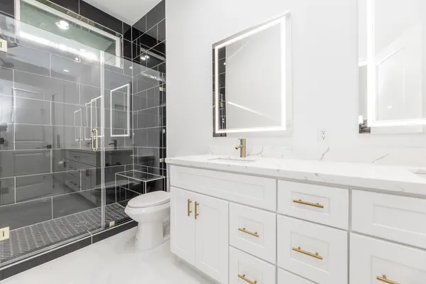 a bathroom with a shower sink and mirror