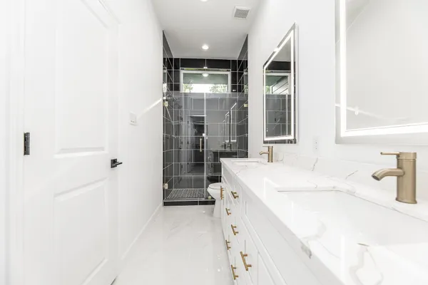 a bathroom with a sink a mirror and a shower