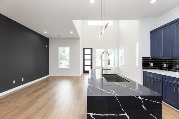 a view of a kitchen with wooden floor and a sink