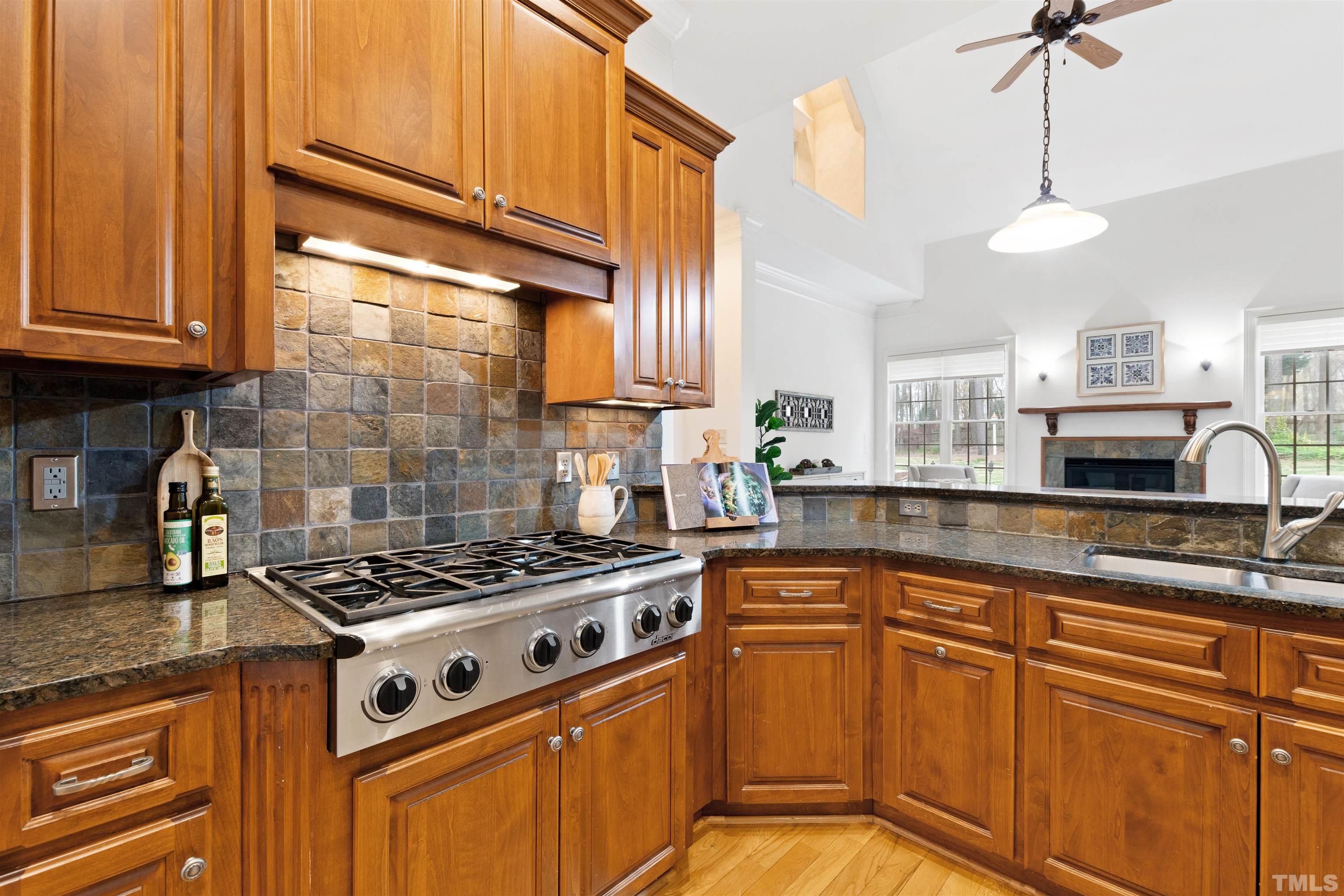 1904 Bowling Green Trail Raleigh, NC 27613 - Photo 16 of 43 a kitchen with stainless steel appliances granite countertop a stove a sink and a microwave