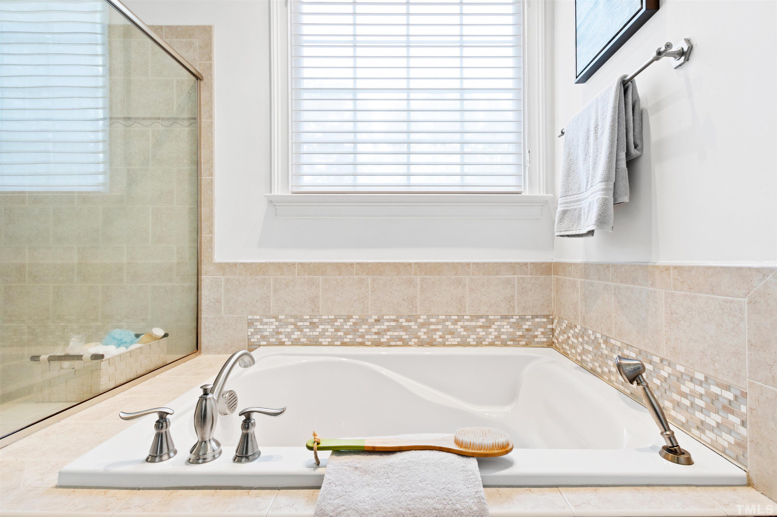 1904 Bowling Green Trail Raleigh, NC 27613 - Photo 19 of 43 a bathroom with bathtub and window