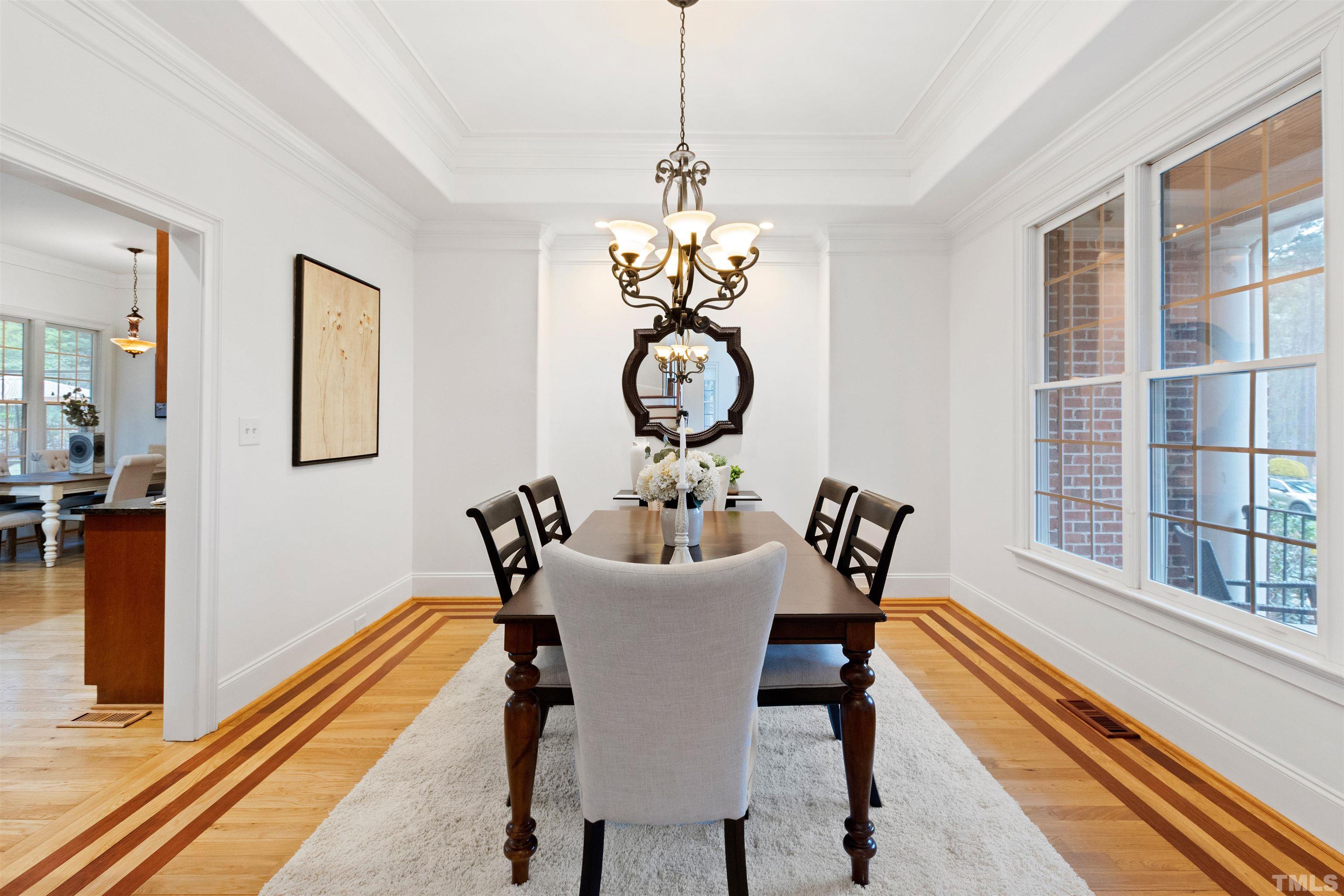1904 Bowling Green Trail Raleigh, NC 27613 - Photo 5 of 43 a dining room with chandelier and wooden floor
